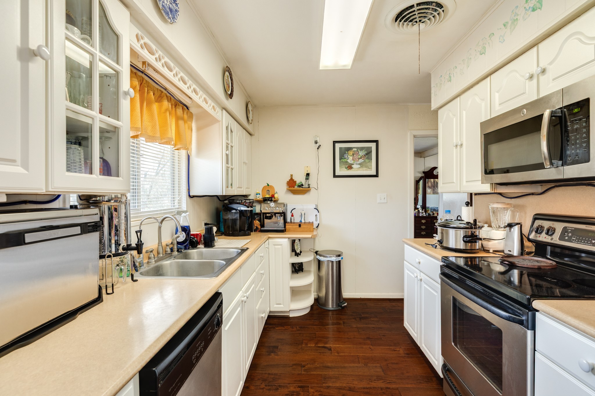703 County Road 605 Angleton, TX 77515 - Photo 29 of 35 a kitchen with stainless steel appliances a stove sink microwave and cabinets