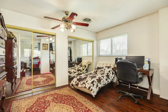 a bed sitting in a bedroom next to a window