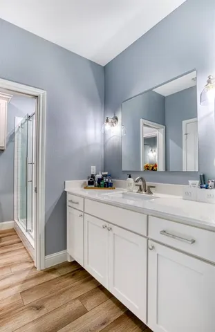 a bathroom with double vanity sink and a mirror