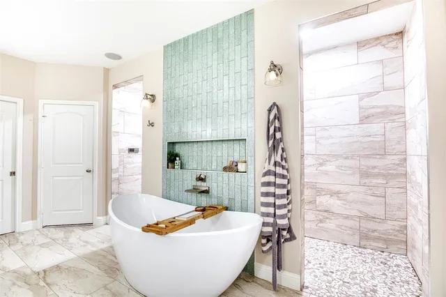 a bath room with a bath tub and shower
