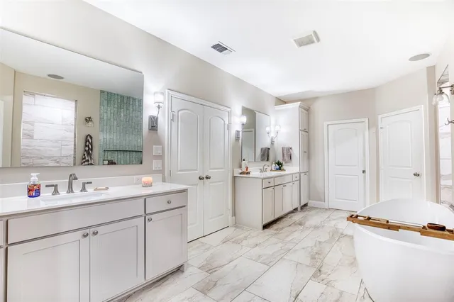 a large white kitchen with a stove a sink a window and a refrigerator