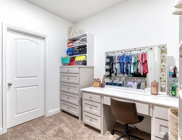 a room with a wooden floor and cabinets