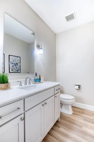 a bathroom with a toilet a sink and a mirror
