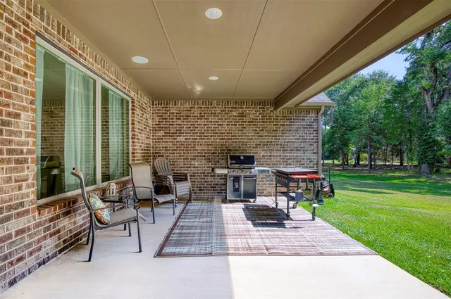 a patio view with a garden and outdoor seating