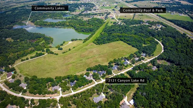 an aerial view of a house a yard and green space