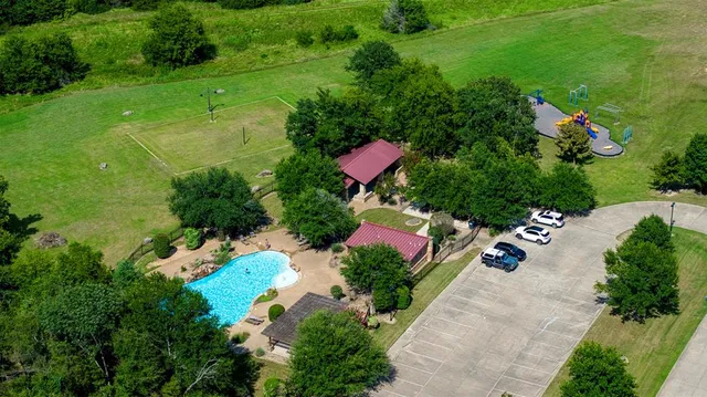 an aerial view of a house with a yard basket ball court and outdoor seating