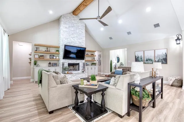 a living room with fireplace furniture and a flat screen tv