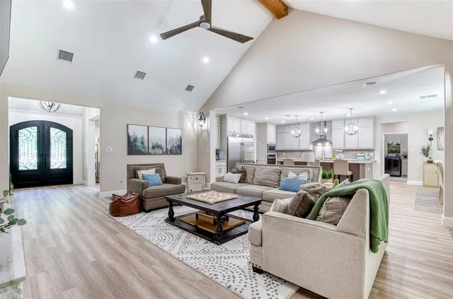 a living room with furniture and a chandelier