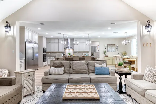 a living room with furniture and kitchen view