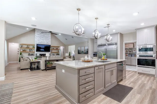 a kitchen with stainless steel appliances granite countertop a stove and cabinets