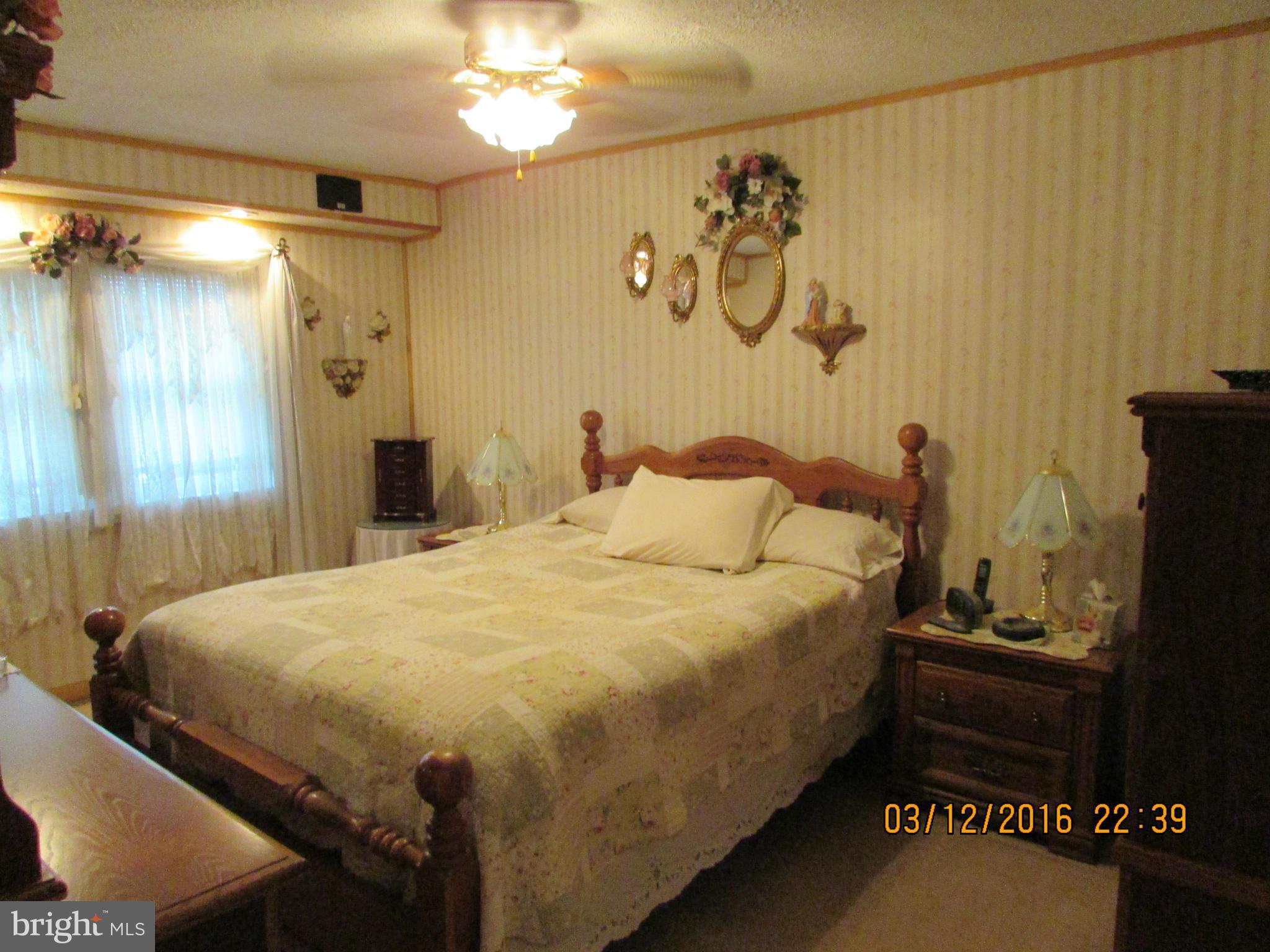 1925 Quentin Road Baltimore, MD 21222 - Photo 14 of 28 a bedroom with a bed and a mirror