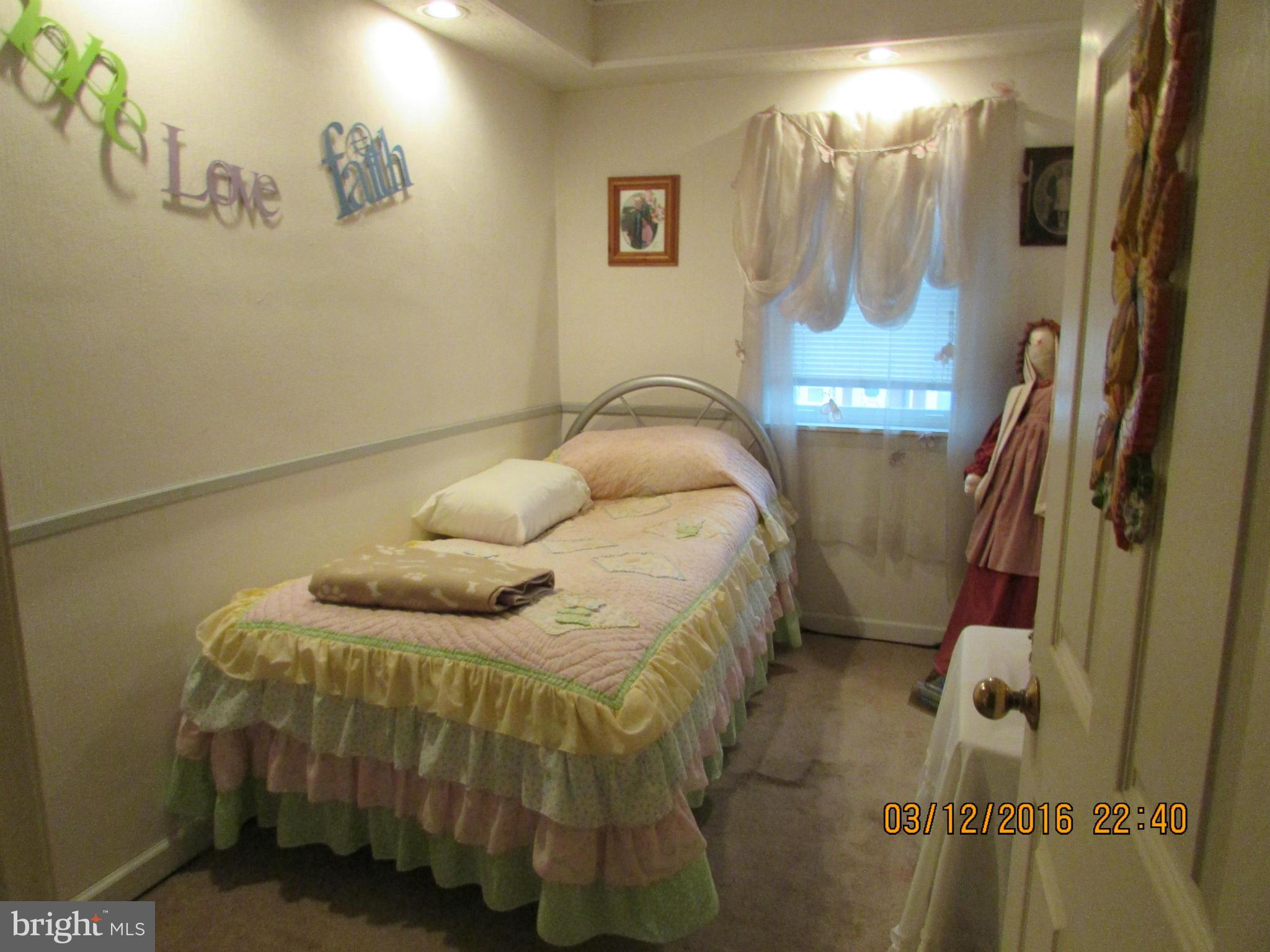 1925 Quentin Road Baltimore, MD 21222 - Photo 15 of 28 a bedroom with a bed and a mirror