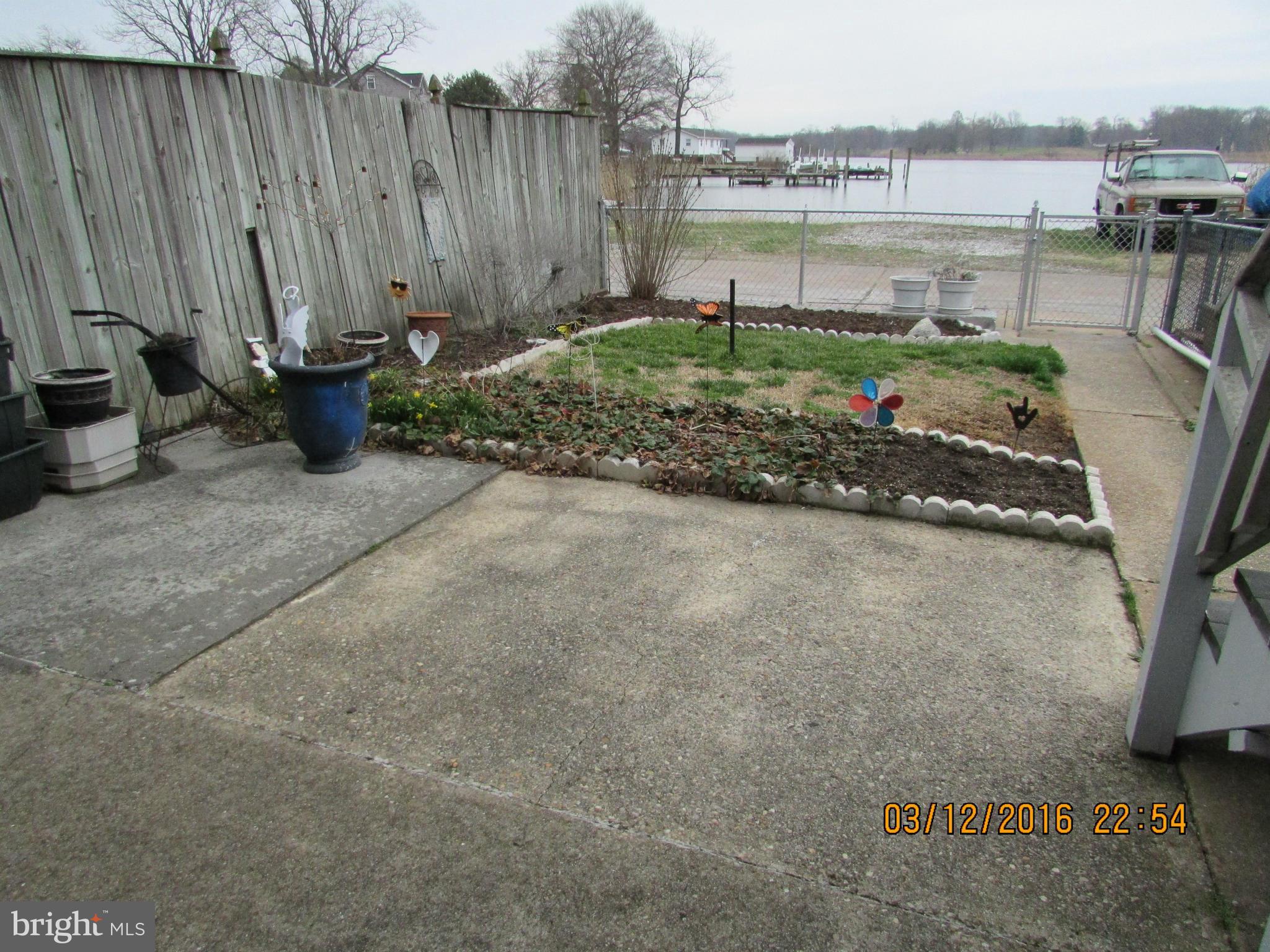 1925 Quentin Road Baltimore, MD 21222 - Photo 22 of 28 a view of a backyard with water fountain and lake view