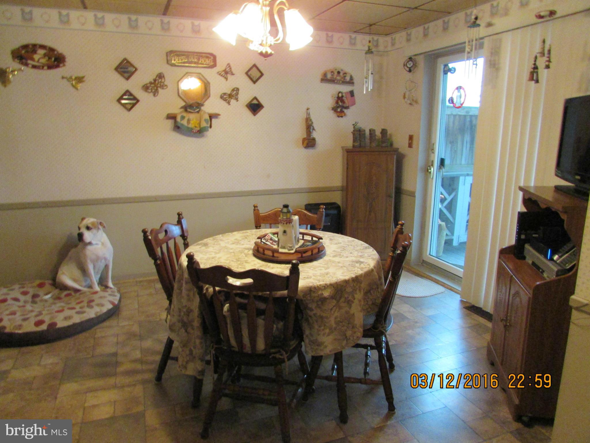1925 Quentin Road Baltimore, MD 21222 - Photo 7 of 28 a view of a dining room with furniture and wooden floor