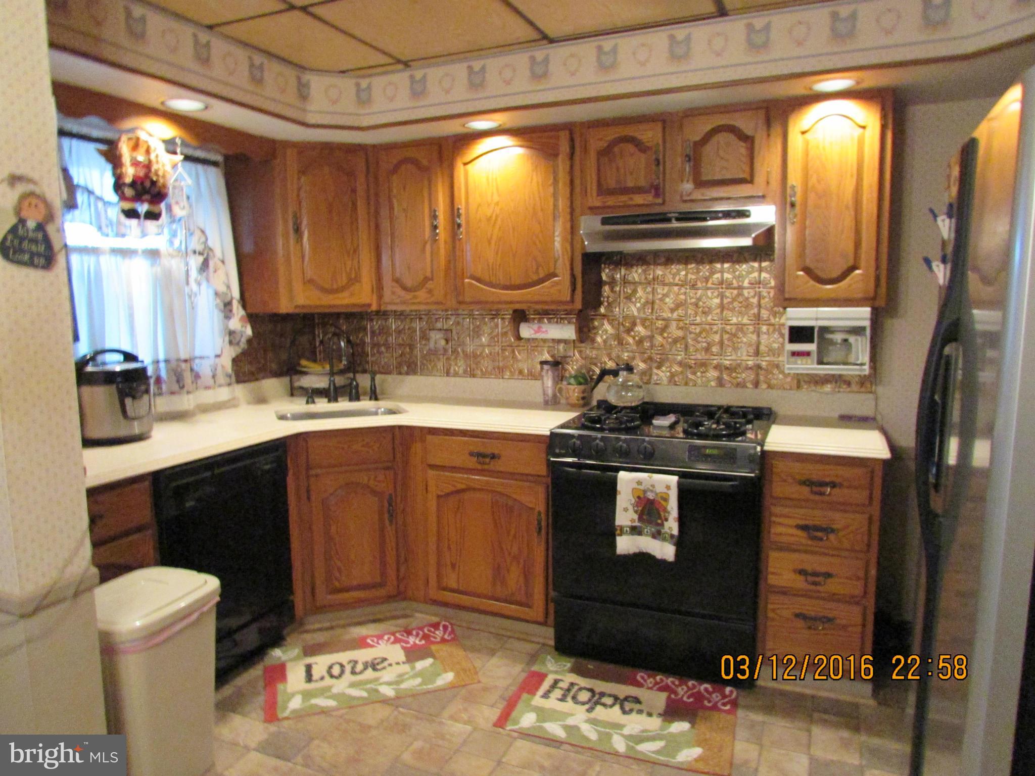 1925 Quentin Road Baltimore, MD 21222 - Photo 9 of 28 a kitchen with stainless steel appliances granite countertop a sink stove and cabinets