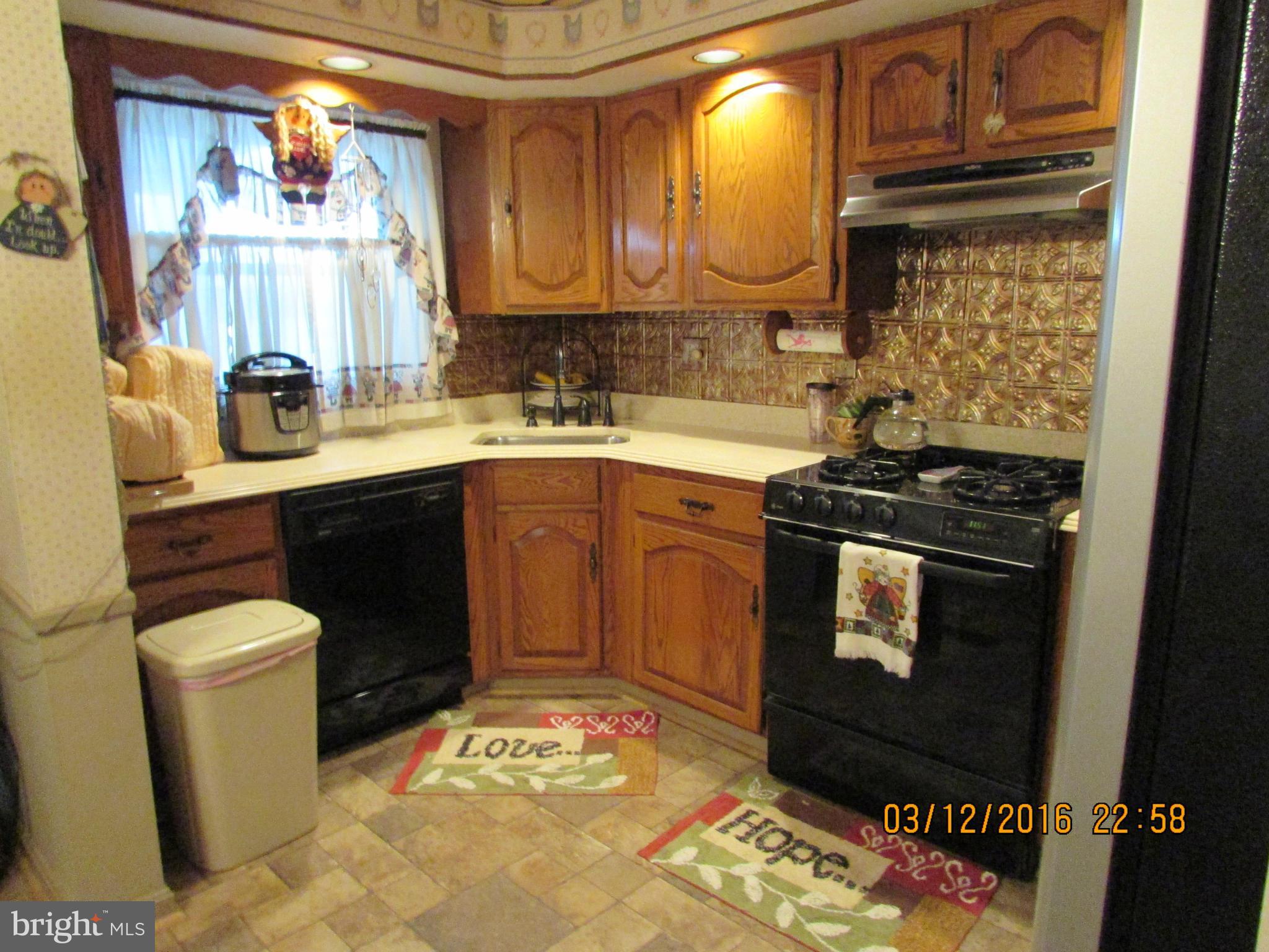 1925 Quentin Road Baltimore, MD 21222 - Photo 10 of 28 a kitchen with a sink stove and cabinets