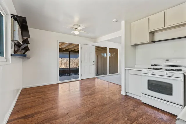 a view of a kitchen with stove and cabinets