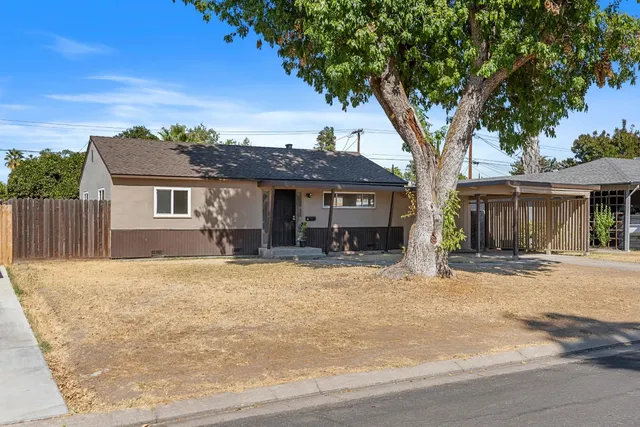 front view of a house with a tree