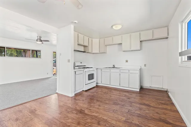 a kitchen with stainless steel appliances a white cabinets and a sink