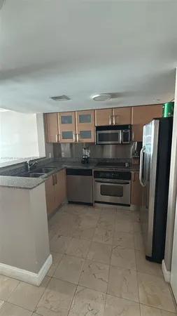 a kitchen with a refrigerator and a sink