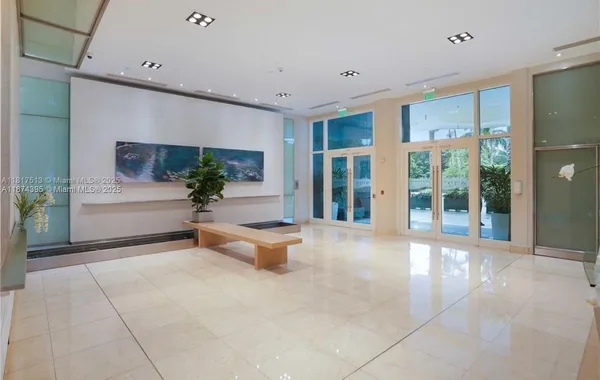 a living room with furniture and large windows