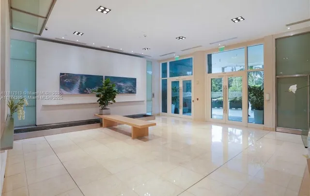 a living room with furniture and large windows