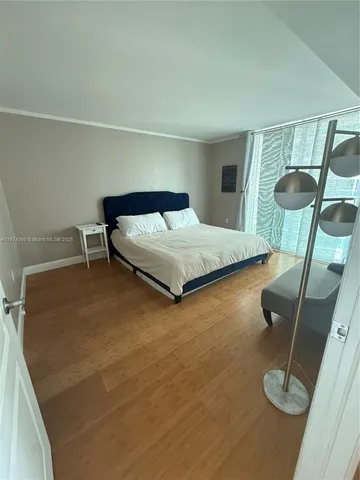 a bedroom with a bed and cabinets