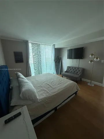 a bedroom with bed and window