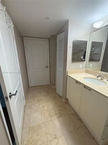a bathroom with a sink a toilet and mirror