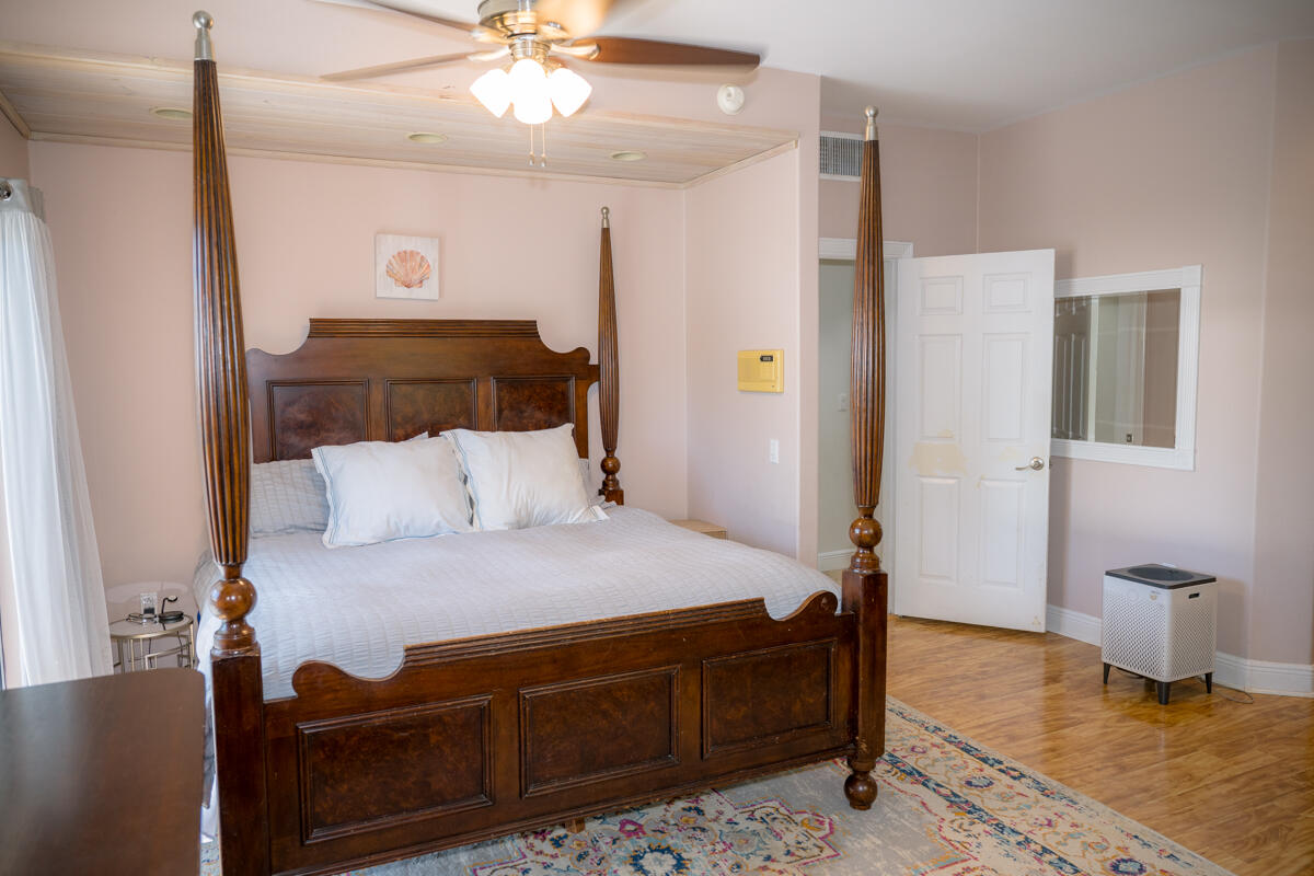 464 Lime Drive Key Largo, FL 33037 - Photo 22 of 96 a bedroom with a bed and a chandelier