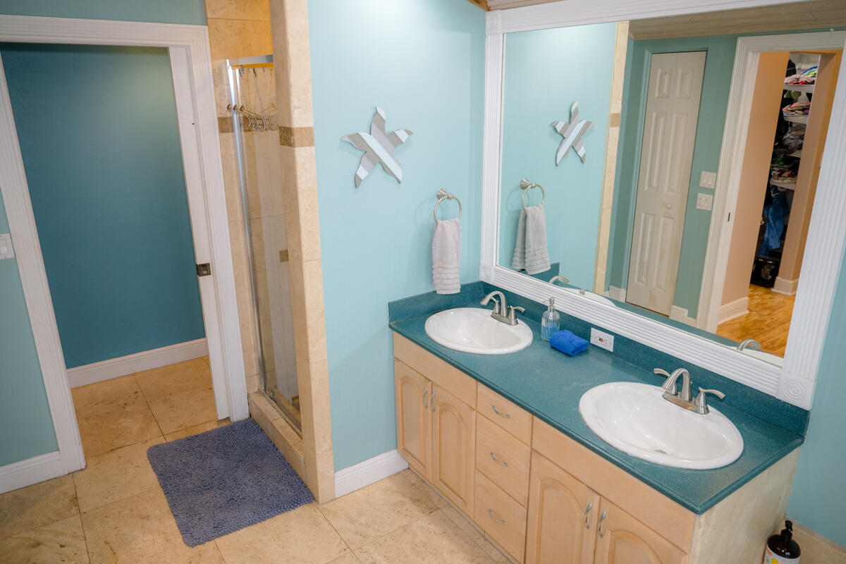 464 Lime Drive Key Largo, FL 33037 - Photo 26 of 96 a bathroom with a granite countertop sink and a mirror