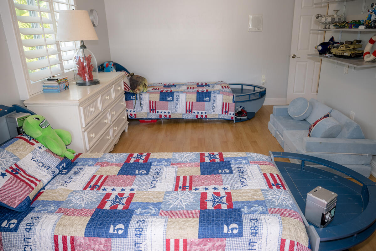 464 Lime Drive Key Largo, FL 33037 - Photo 39 of 96 a bedroom with furniture and a book shelf