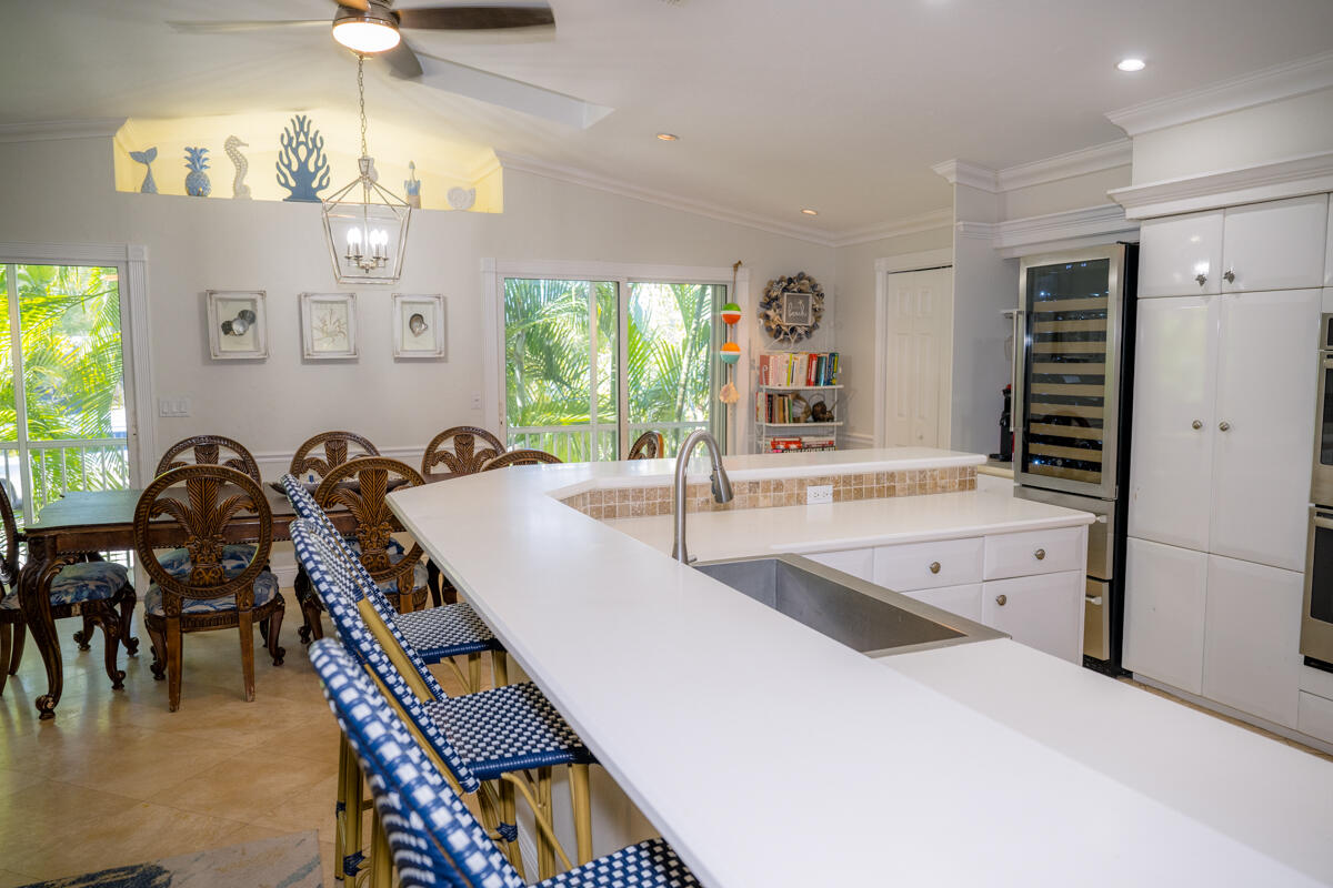 464 Lime Drive Key Largo, FL 33037 - Photo 57 of 96 a large kitchen with a table and chairs