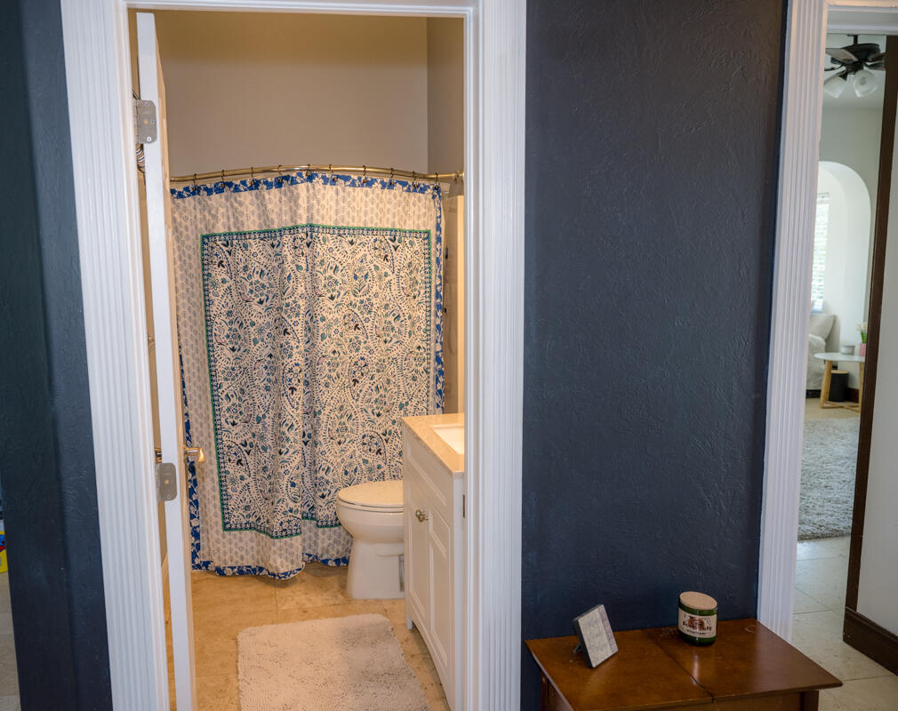 464 Lime Drive Key Largo, FL 33037 - Photo 81 of 96 a bathroom with a toilet and a shower curtain