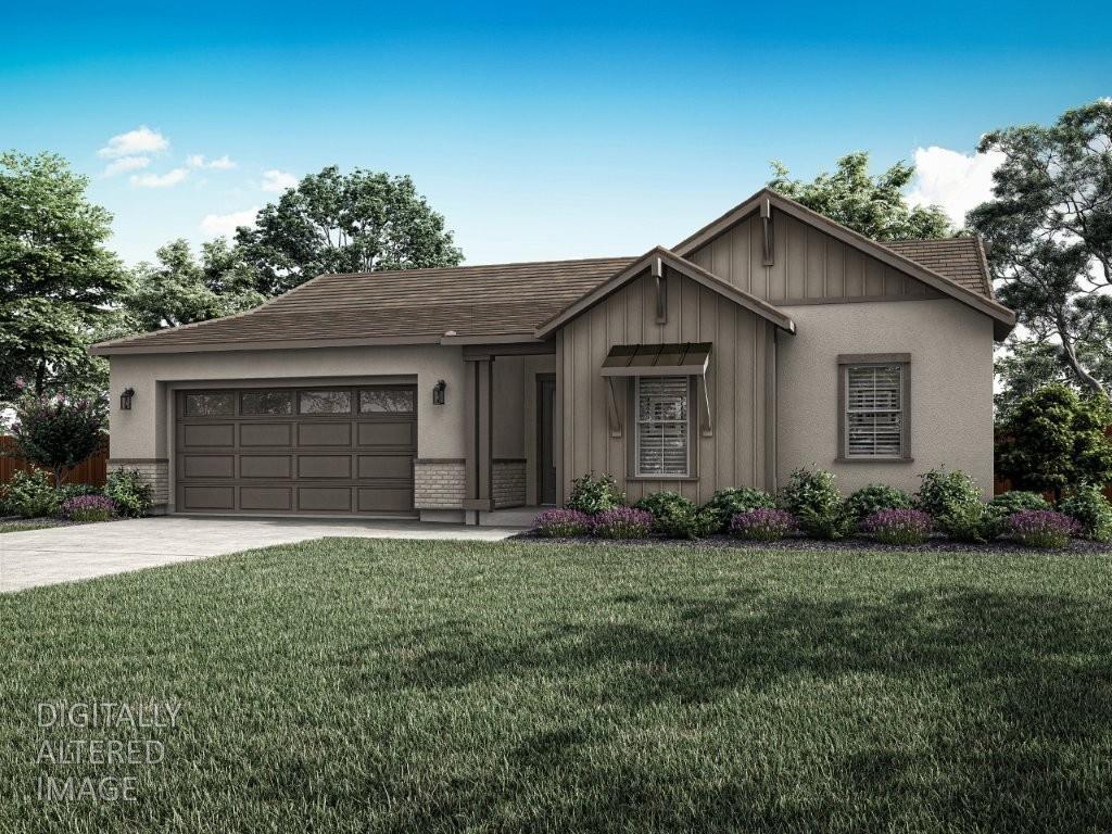 a front view of a house with a garden and yard