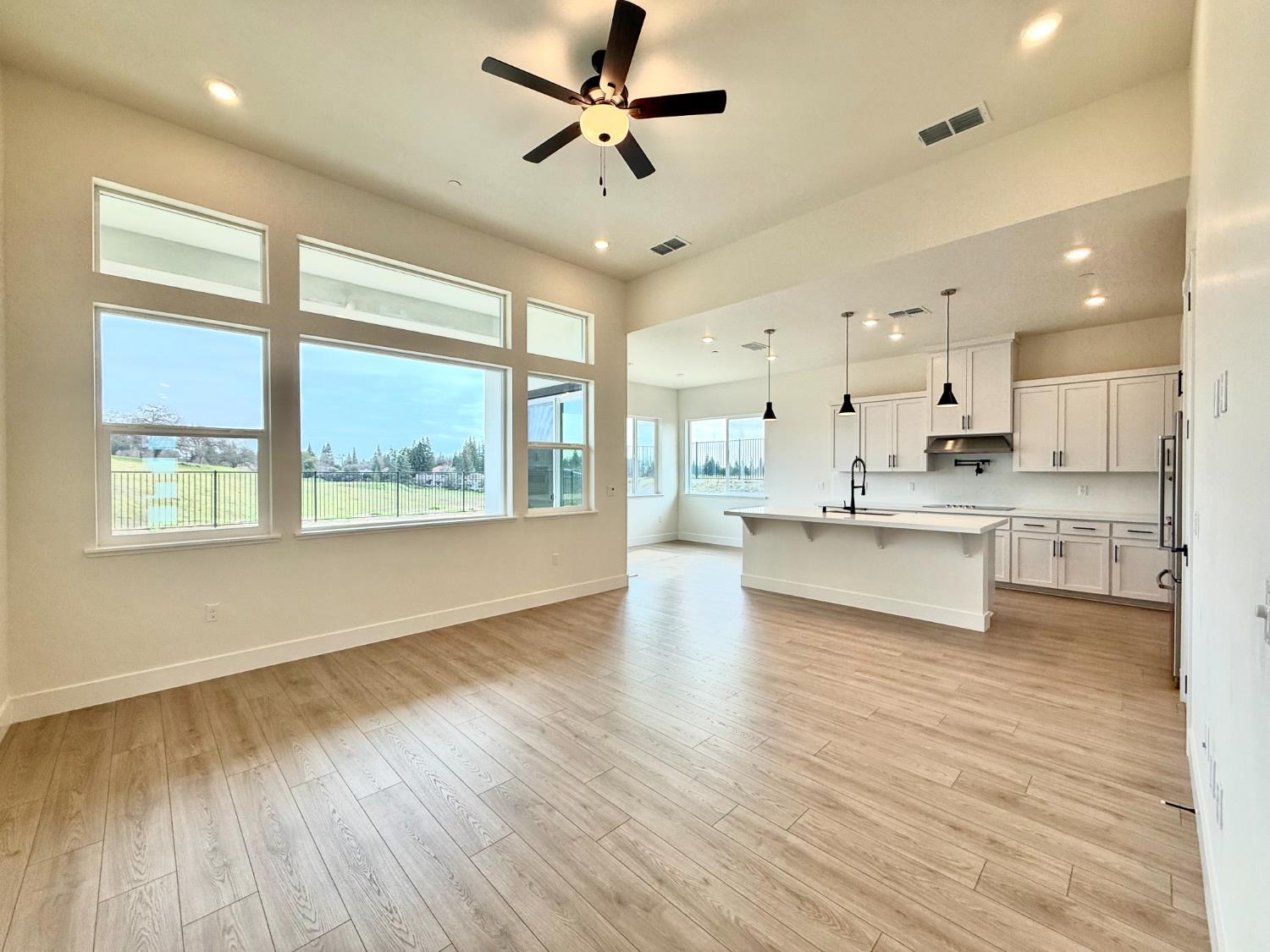 7056 Dalton Rnch Drive Rancho Murieta, CA 95683 - Photo 2 of 29 a large kitchen with stainless steel appliances a large window a oven and a large window with wooden floors