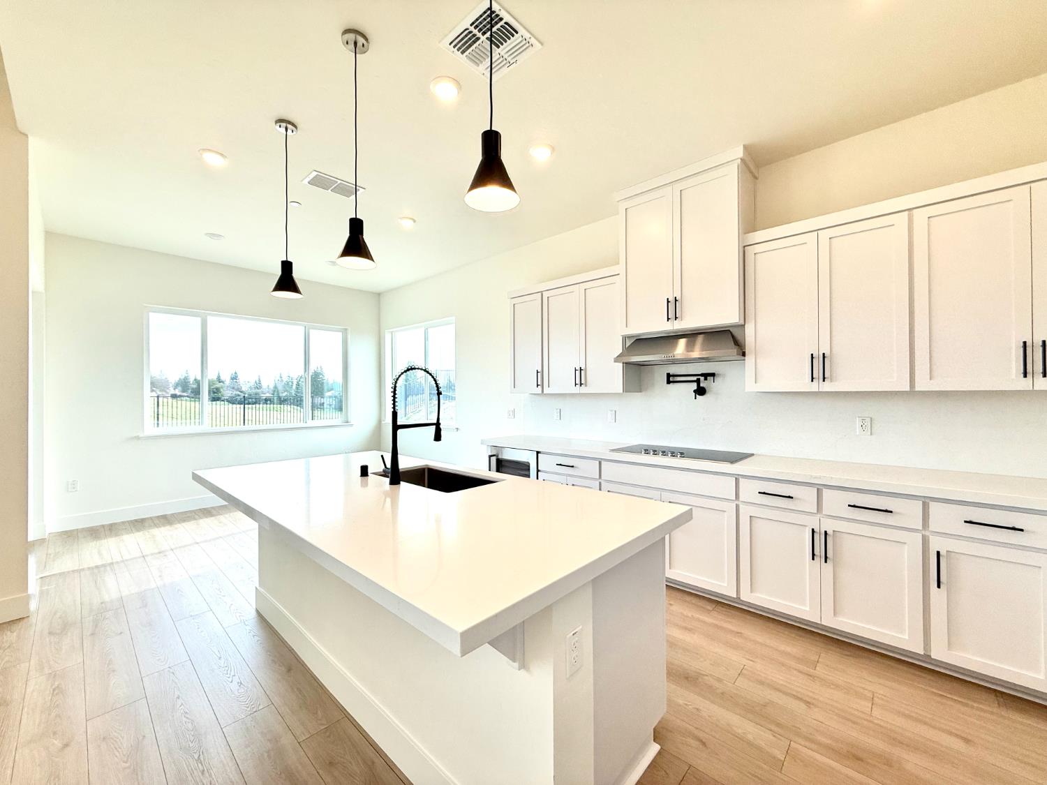 7056 Dalton Rnch Drive Rancho Murieta, CA 95683 - Photo 4 of 29 a kitchen with kitchen island a sink a stove and center island