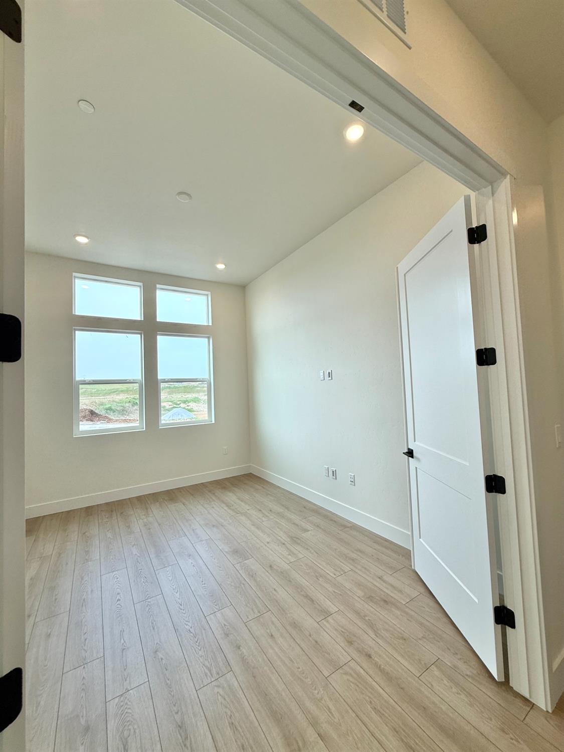 7056 Dalton Rnch Drive Rancho Murieta, CA 95683 - Photo 8 of 29 an empty room with wooden floor and windows