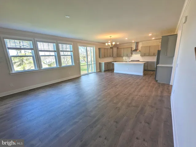a view of kitchen with windows and refrigerator