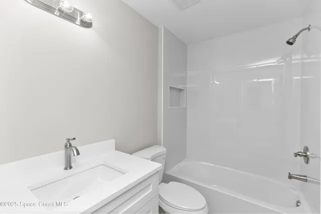 a bathroom with a sink toilet and bathtub