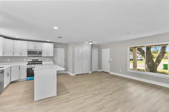 a view of a kitchen with a sink and a stove top oven