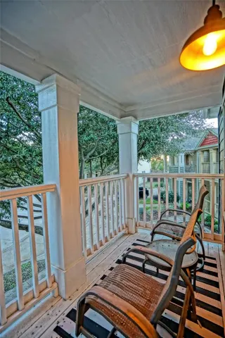 a view of a backyard with potted plants and wooden fence