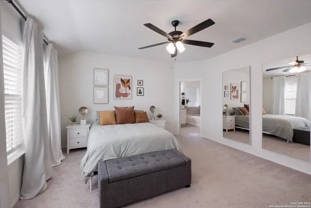 a spacious bedroom with a bed and a large window