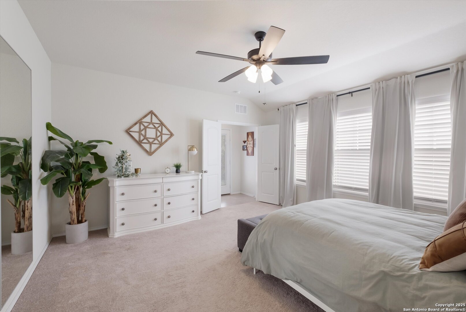 9029 Curling Post Schertz, TX 78154 - Photo 18 of 53 a bedroom with a bed chandelier dresser and a window