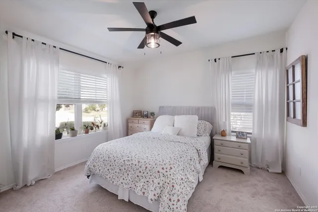 a bedroom with a bed next to a window