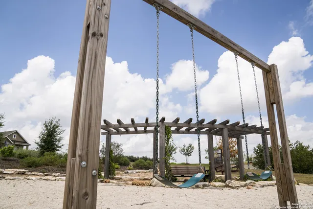 a patio with table and chairs and potted plants