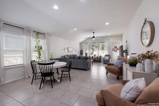 a living room with furniture two window and a table
