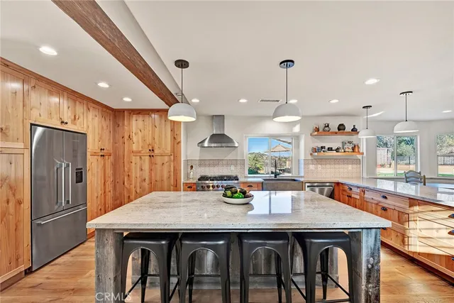a large kitchen with stainless steel appliances granite countertop a large center island and a stove