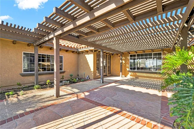 a view of a house with backyard porch and sitting area