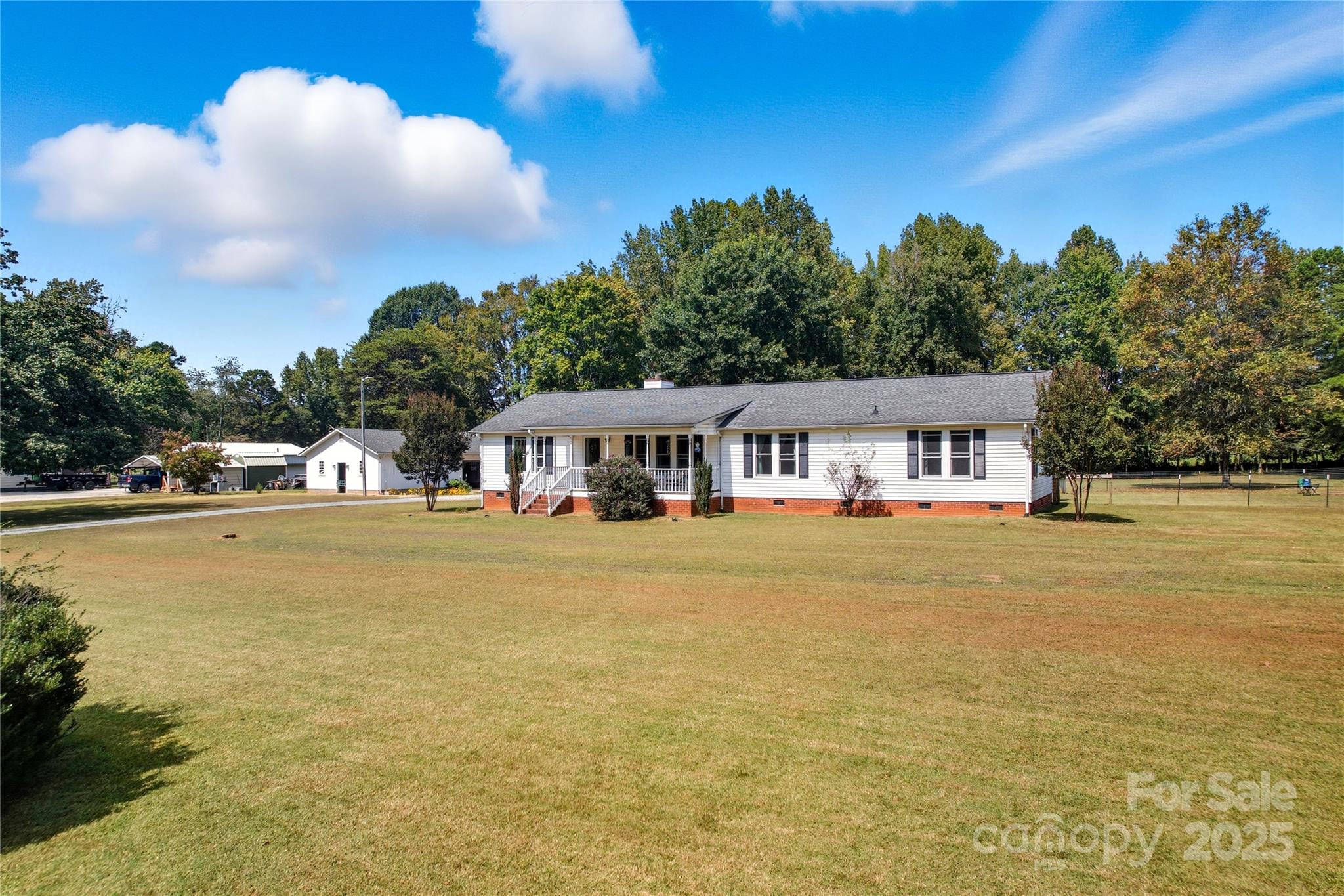 a front view of house with yard and lake view